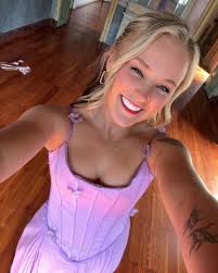 JoJo Siwa donned a gold sequined cape dress to attend her good friend and  fellow “Dance Moms” alum Kalani Hilliker's wedding in Italy. ✨ 📸: Instagram