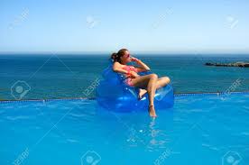 25 pool floats for adults who know how to party. Beautiful Young Woman Sitting On Inflatable Chair Sunbathing Relax In Swimming Pool With Wonderful Sea Views Stock Photo Picture And Royalty Free Image Image 22737073