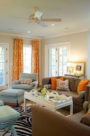 This modern living room showcases bright orange walls contrasted with a grey sofa, round coffee table, and pendant lights. In Need Of Decorating Ideas Added Pics Living Room Orange Blue And Orange Living Room Living Room White