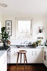 For contrast, she chose an emerald green tone from the wallpaper to paint the kitchen's island. Kitchen Trend No Upper Cabinets Emily A Clark