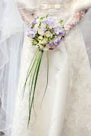 Spring arrangement w/ lily, iris, orchid, peach rose. Bride Holds A Wedding Bouquet Of Roses And Irises Stock Photo Picture And Royalty Free Image Image 40518641