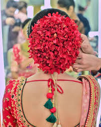 Red Floral Bun With A Traditional Bridal Look Bridal Hairdo Wedding Hair Accessories Bridal Hair