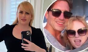 Wilson introduced her new beau, jacob busch, in a casual group shot in front of a helicopter last week. Rebel Wilson Shows Off Her Slimmed Down Figure As She Returns Home After A Trip With Her Boyfriend Daily Mail Online