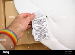 POV male hand holding instruction manual and composition of Peg Perego  padded cushion for high chairs or stroller with the address of manufacture  in Stock Photo - Alamy