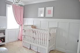 Light gray nursery furnished with a white crib displaying a collection of art framed overhead. Ava S Sweet Gray And Pink Nursery Project Nursery