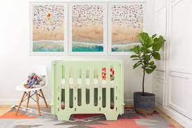 The large wall map from national geographic is the focus of the room, and gives an antique vibe to carter's happy nursery. How To Curate A Travel Themed Nursery Gray Malin