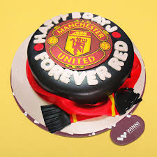 Chocolate cake with hand cut man utd logo, with matching vanilla cupcakes. Manchester United Cake Winni In