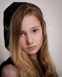 All the secrets to enhance your look. Portrait Of A Beautiful Young Girl With Long Blond Hair Brown Eyes Wearing A Hoodie Jumper Isolated Against A Grey Background Stock Photo Picture And Royalty Free Image Image 30400021