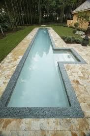 Narrow Pool With Steps Highlighted And Clad With Pebbles For A Natural Feel Lap Pools Backyard Lap Pool Designs Small Backyard Pools