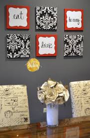 Single wall kitchen with red cabinets and black island. Red And Black Damask Eat Drink Be Merry Chef Wall Decor Set