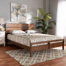 The headboard has a slatted design that adds a touch of farmhouse style to this sleek frame. Modern Wood Bed Frame Design