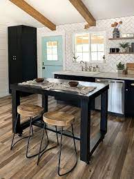 The small kitchen dining table has a wood surface that matches the countertops. Pin On Future