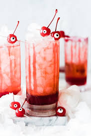 The shirley temple consists of ginger ale and a splash of grenadine, topped with maraschino cherries. Shirley Temple Recipe Oh So Delicioso