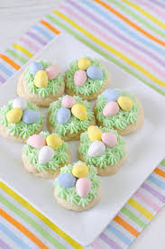 White cupcakes with a chocolate egg in the center, thick, colorful icing, and topped with a chocolate mini egg!!! Mini Egg Recipes For Easter Clean And Scentsible