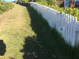 Picture of a house on a grassy hill with fluffy clouds in the sky and a white picket fence. White Picket Fence Diaries From The Hill