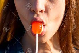 Close-up Of A Girl Sucking A Candy On A Chupa Chups Sticking A Candy With  Her Lips Stock Photo, Picture and Royalty Free Image. Image 76660173.