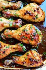 Seasoned drumsticks on a baking tray. Honey Garlic Baked Chicken Drumsticks Craving Tasty