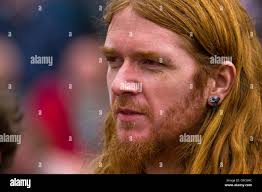 Young ginger male with long hair, beard and ear-ring Stock Photo