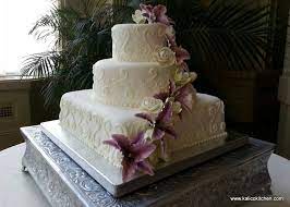 A Three Tier Fondant Wedding Cake With Scroll Work Sugar Roses And Sugar Lillies Square Wedding Cakes Tiered Wedding Cake Wedding Cakes
