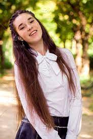What a cute look to give your little girl. Nominated Portrait Of A Cute Young Girl With Long Brown Hair With A Beautiful Smile One Person Young Adult Young Women Real People Lifestyles Beautiful Woman Leisure Activity Hairstyle Hair Outdoors Brown