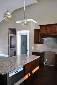 Dark Brown Kitchen Cabinets Granite Counter Tops White Trim Beige Paint Pantry Door W Dark Brown Kitchen Cabinets Brown Kitchen Cabinets Kitchen Wall Colors