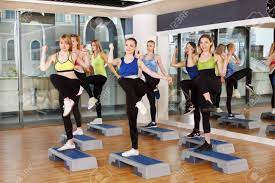 Group Of Young Women In Fitness Club Do Step Aerobics. Girls At Step Do Leg  Kicks. Healthy Lifestyle At Gym Studio. Slimming Workout Stock Photo,  Picture And Royalty Free Image. Image 59482348.
