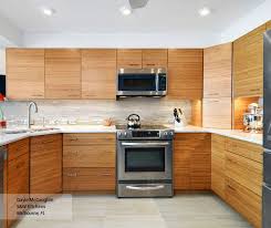 Knotty alder cabinets, shaker style cabinets, brick back splash, walnut floors, farm apron sink, island, farm house style. Natural Bamboo Kitchen Cabinets Omega Cabinetry Bamboo Kitchen Cabinets Kitchen Cabinets Bamboo Cabinets