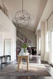 30 Entryways With Dramatic Lighting To Give Your Guests A Warm Welcome Entryway Lighting Foyer Lighting Entryway Chandelier