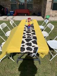 I Used Yellow Table Cover And Cow Cover And Centerpiece In Middle Made Out Of A Pickle Jar Blue In 2020 Toy Story Party Decorations Toy Story Birthday Toy Story Party