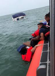 coast guard rescues four from sinking