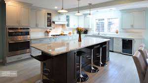 Here, gold handles connect white cabinets to complementary light green cabinetry beneath a white marble counter. Light Grey Kitchen With Dark Grey Island Cabinets Omega