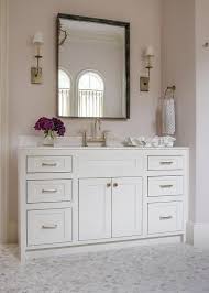 Herringbone marble tile (a beautiful mess). White Washstand With Pale Pink Walls Transitional Bathroom