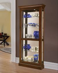 Finished in a distressed sand shell white, this corner curio cabinet is constructed out of solid hardwoods and will last for lifetimes to come. Cherry Curio Cabinet Cherry Curio Cabinet Cabinet Glass Cabinets Display