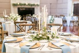 Elegant Simplicity In This Reception Centerpiece Of Eucalyptus And Olive Leaf Greenery Nestled Within A Round Wedding Tables Wedding Table Wedding Centerpieces