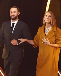 Celine Dion made a surprise appearance at the Grammys to present Album of  the Year and her 23-year-old son Rene-Charles walked her on stage. She wore  Valentino with Tiffany jewlery. More photos