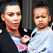 Kim Kardashian tries to put a smile