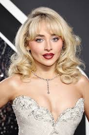 No she doesn't look 50. Her makeup style is Hollywood glam, which is like  the 80s over the top, big eyes bigger than life personality. She's acing  this look for sure!