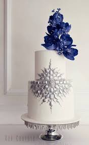 What's not to love about a floral wedding cake? Two Tier Blue Flower Topped Wedding Cake