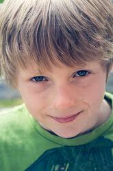 Austria, Boy laughing and looking away, close up stock photo