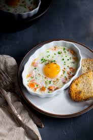 Layer smoked salmon, thinly sliced cucumber and black pepper between 4 slices of soft, buttered bread in this order: Baked Eggs With Smoked Salmon And Chives Taming Of The Spoon