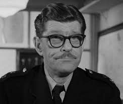 Deryck Guyler A English Actor best known for portraying officious  characters in film ,TV and radio. Best known for "Please Sir" And Constable  Corky in "Sykes".He was in a nice black and
