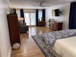 A bench or a loveseat look lovely at the foot of the bed in a long room. How To Layout And Decorate A Long Narrow Bedroom Designed