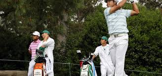Matsuyama lines up a putt with his caddie, shota hayafuji, on the 18th green. R12kprqhqo5m