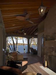 Patio Ceiling Fans With Lights With Traditional Patio And Ceiling Fan Covered Patio Iron Railing Lantern Outdoor Ceiling Fan Outdoor Fireplace Rafters Water View Wicker Furniture Wood Deck Finefurnished Com
