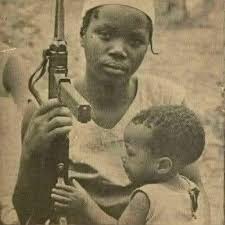 From inbox Chair! This lady reminds me of you. This is what you do, except  that the microphone is your weapon. She was a young South Africa freedom  fighter who took up