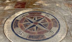 A Stamped Compass Medallion Is A Great Way To Add A Focal Point To Your Driveway And Make A Dramati Driveway Design Brick Patterns Patio Concrete Patio Designs