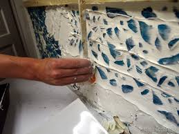 Take a few jars and break them into pieces. Mason Jar Mosaic Backsplash Reality Daydream