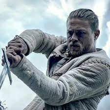 The charlie hunnam king arthur hairstyle is a slicked back wet look medium length undercut style with a short back & sides. Charlie Hunnam King Arthur Hair What Is The Haircut How To Style Regal Gentleman