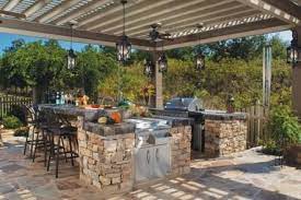 Rustic wood kitchen with stone backdrop. 33 Amazing Outdoor Kitchens Outdoor Kitchen Design Outdoor Kitchen Outdoor Kitchen Patio