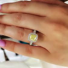 Cushion cut halo engagement rings feature both the soft, rounded corners of the cushion cut and the dazzling halo of accent diamonds encircling the center stone. 3 10 Ct Canary Fancy Yellow Halo Cushion Cut Diamond Engagement Ring Kingofjewelry Com